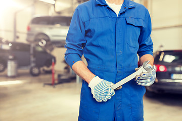 Image showing auto mechanic or smith with wrench at car workshop