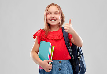 Image showing student girl with books and bag showing thumbs up