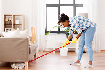 Image showing african woman or housewife cleaning floor at home