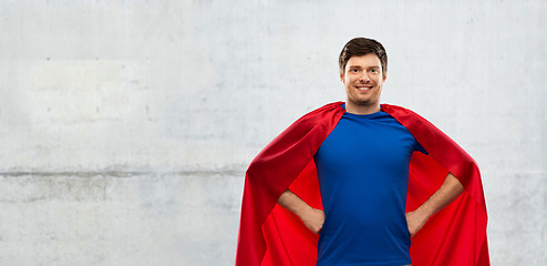 Image showing man in red superhero cape over concrete background