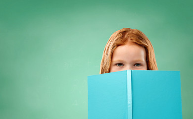 Image showing red student girl with book over school chalk board