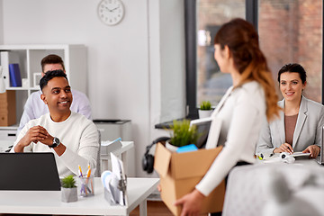 Image showing happy employee with personal stuff at office