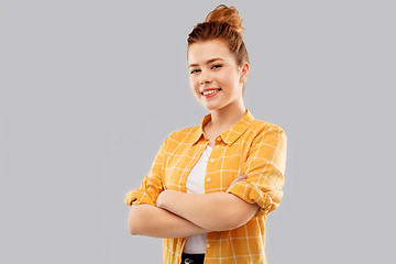 Image showing smiling red haired teenage girl with crossed arms