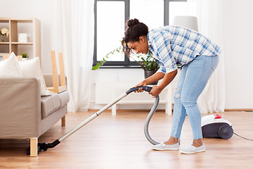 Image showing woman or housewife with vacuum cleaner at home