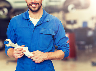 Image showing auto mechanic or smith with wrench at car workshop