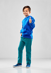 Image showing smiling boy in blue hoodie showing thumbs up