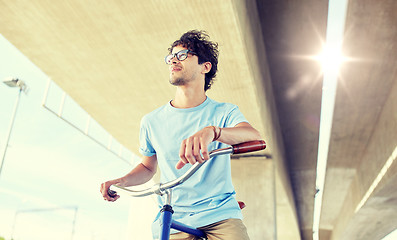 Image showing young hipster man riding fixed gear bike