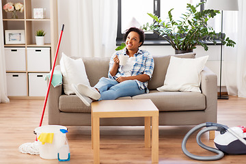 Image showing woman drinking coffee or tea after cleaning home