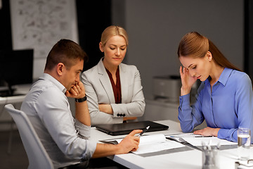 Image showing business team with laptop working at night office