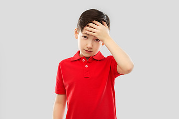 Image showing sick boy in red t-shirt suffering from headache