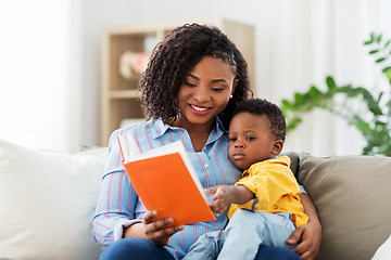 Image showing african american mother with book and baby at home