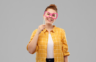 Image showing smiling red haired teenage girl with big glasses