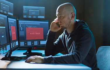 Image showing hacker with no access on computer calls on cell
