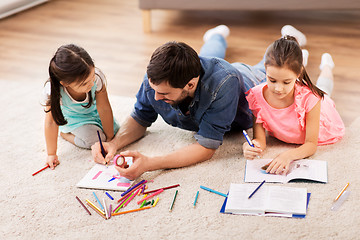 Image showing father with little daughters drawing at home