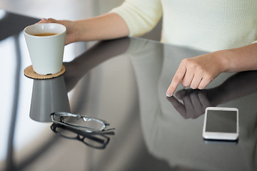 Image showing woman with coffee using black interactive panel