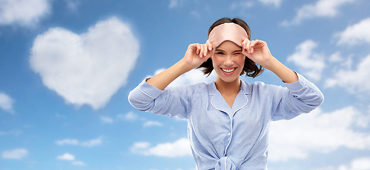 Image showing happy young woman in pajama and eye sleeping mask