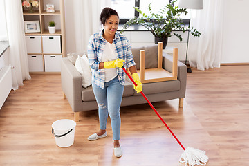 Image showing african woman or housewife cleaning floor at home