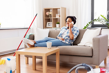 Image showing woman calling on smartphone after home cleaning