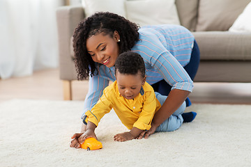Image showing mother and baby playing with toy car at home