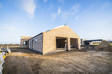 Image showing Brick house construction site in a new neighborhood