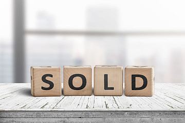 Image showing Sold sign on a wooden table
