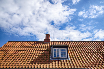 Image showing Tiled red roof with a rooftop window