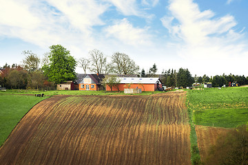 Image showing Farm on the top of a hill with cultivated fields