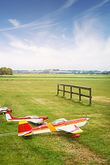 Image showing Model airplanes ona line on a green field