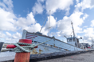 Image showing Fishing boat in a Scandinavian harbor in retro blue