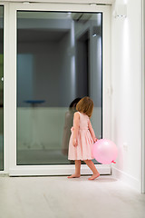 Image showing cute little girl playing with balloons