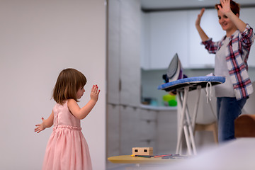 Image showing mother and little daughter spending time together at home