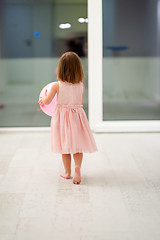 Image showing cute little girl playing with balloons