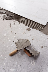 Image showing Ceramic wood effect tiles and tools for tiler on the floor