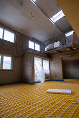 Image showing yellow underfloor heating installation with white pipes