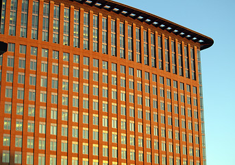 Image showing red building with lots of windows in blue sky