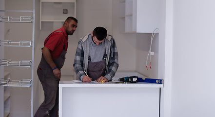 Image showing workers installing a new kitchen