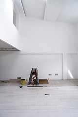 Image showing worker installing the ceramic wood effect tiles on the floor