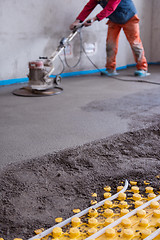 Image showing worker performing and polishing sand and cement screed floor