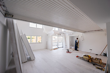 Image showing carpenters installing glass door with a wooden frame