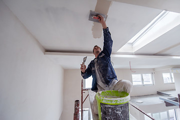 Image showing construction worker plastering on gypsum ceiling