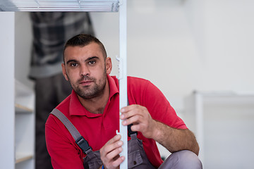 Image showing worker installing a new kitchen