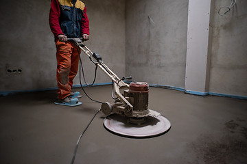 Image showing worker performing and polishing sand and cement screed floor