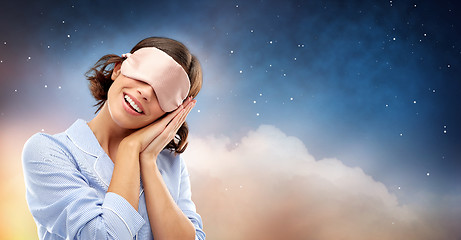 Image showing happy young woman in pajama and eye sleeping mask