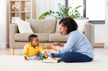 Image showing mother and baby playing with toy blocks at home