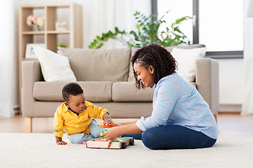 Image showing mother and baby playing with toy blocks at home