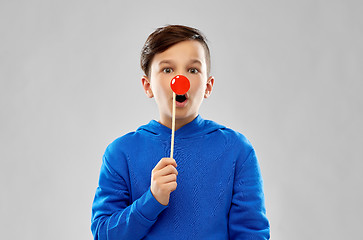 Image showing shocked boy in blue hoodie with red clown nose