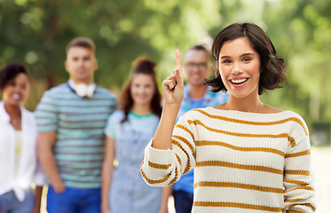 Image showing happy woman showing one finger or pointing up