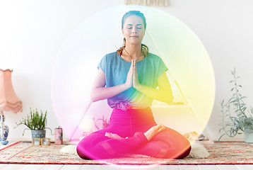 Image showing woman meditating in lotus pose at yoga studio