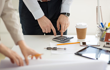 Image showing close up of businessman with calculator at office