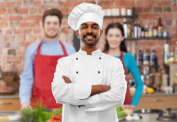 Image showing happy male indian chef in toque at cooking class